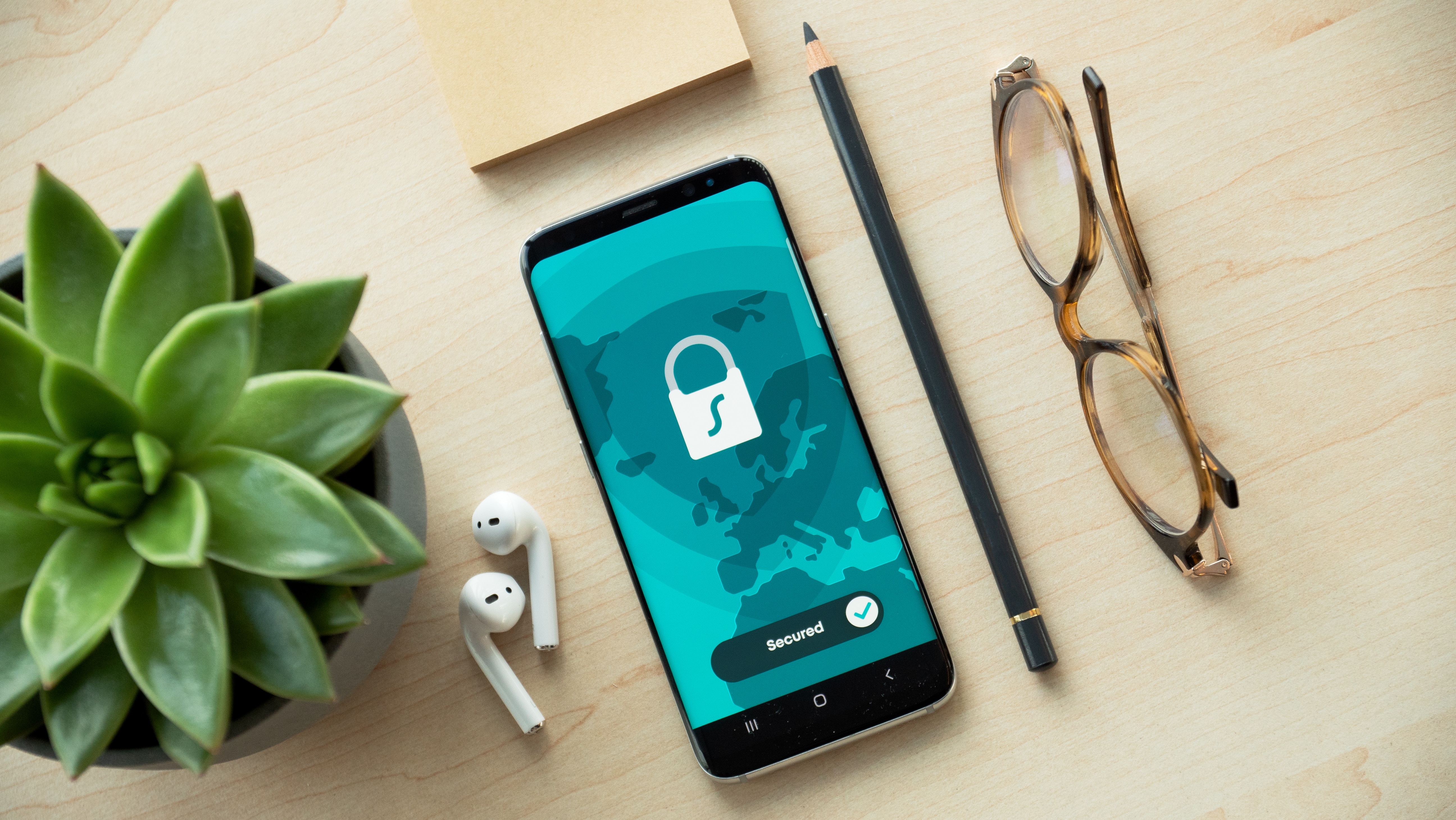 Phone with lock icon next to pencil and glasses